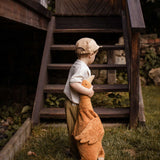 A child holding a Senger Large Cuddly Goose organic soft toy in a dark orange Rust colour. These soft toys are created from the highest quality, sustainable and traceable natural materials. Senger cuddly animal toys and soft dolls are handmade in Germany with love and attention to detail and we are proud Senger stockists here at Babipur. 