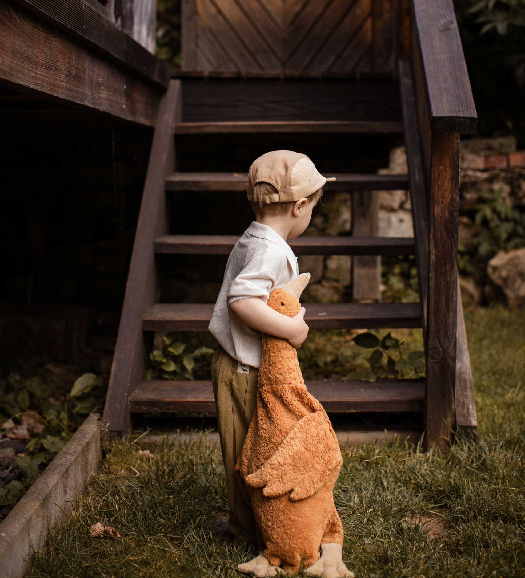 A child holding a Senger Large Cuddly Goose organic soft toy in a dark orange Rust colour. These soft toys are created from the highest quality, sustainable and traceable natural materials. Senger cuddly animal toys and soft dolls are handmade in Germany with love and attention to detail and we are proud Senger stockists here at Babipur. 