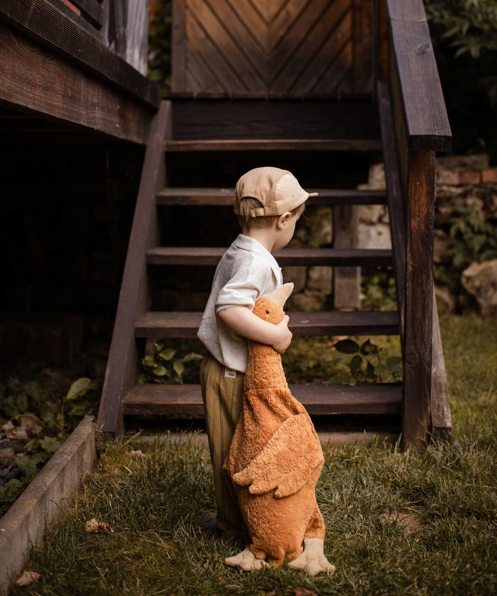 A child holding a Senger Large Cuddly Goose organic soft toy in a dark orange Rust colour. These soft toys are created from the highest quality, sustainable and traceable natural materials. Senger cuddly animal toys and soft dolls are handmade in Germany with love and attention to detail and we are proud Senger stockists here at Babipur. 