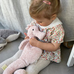 A child cuddling the Senger Large Cuddly Seahorse.