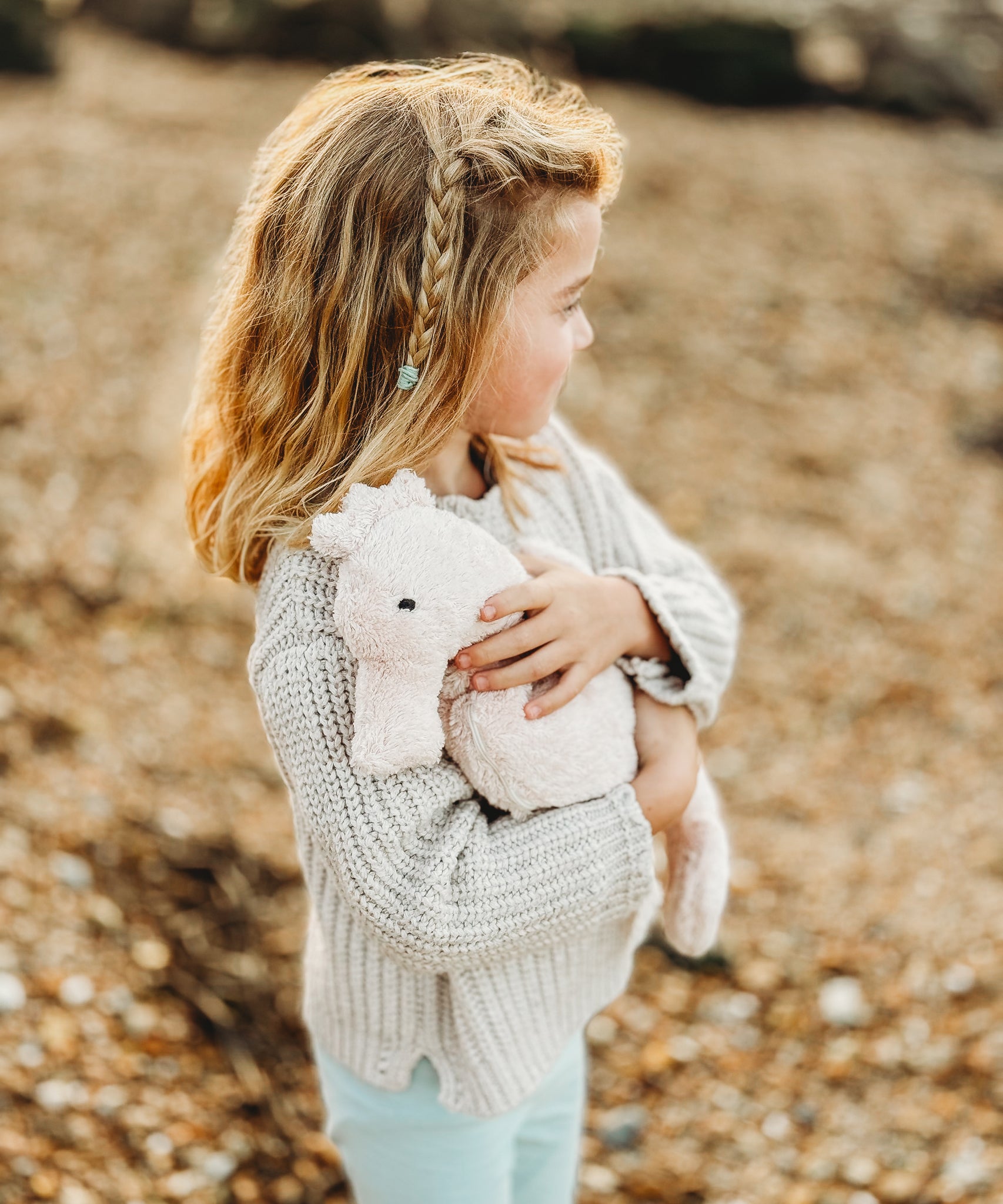 A child cudling the Senger Large Cuddly Seahorse soft toy.