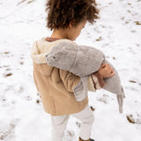Child carrying a large Senger grey cuddly soft toy in the snow