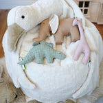 A close up of a Senger Goose bean bag shown with smaller Senger animal baby clutching toys placed on it.