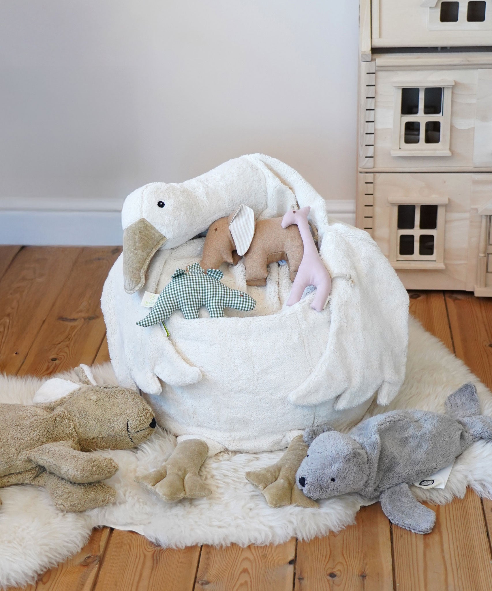 A Senger Goose bean bag shown with smaller Senger animals placed on it.