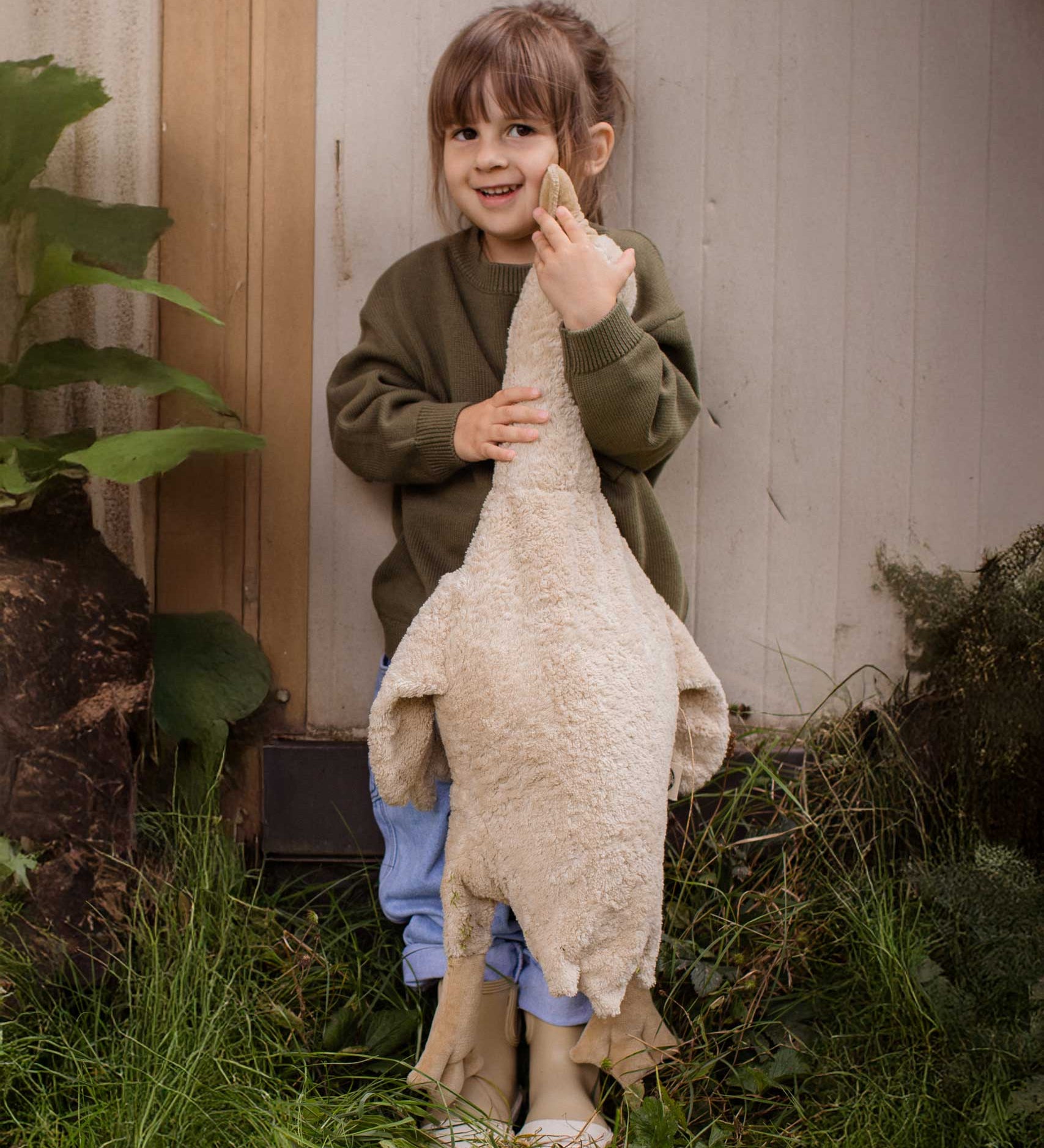 A child holding a Senger Large Cuddly Goose organic soft toy in a creamy Linen colour. These soft toys are created from the highest quality, sustainable and traceable natural materials. Senger cuddly animal toys and soft dolls are handmade in Germany with love and attention to detail and we are proud Senger stockists here at Babipur. 