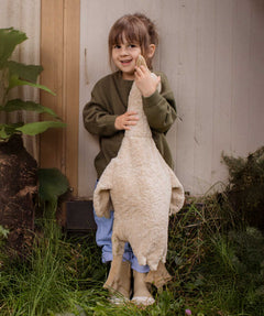 A child holding a Senger Large Cuddly Goose organic soft toy in a creamy Linen colour. These soft toys are created from the highest quality, sustainable and traceable natural materials. Senger cuddly animal toys and soft dolls are handmade in Germany with love and attention to detail and we are proud Senger stockists here at Babipur. 