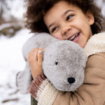 A child cuddling the large Senger grey seal.