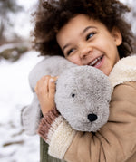 A child cuddling the large Senger grey seal.
