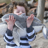 A child holding the large and small Senger cuddly whale animal soft toys.