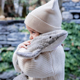 Child hugging the Senger Naturwelt Small Cuddly Shark, organic GOTS cotton plush soft toy with removable heat cushion.