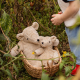 Senger Naturwelt Large and Small Cuddly Bears in Linen sitting in a woven basket, organic GOTS cotton heatable soft toys.