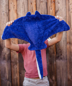 A person holding up the Senger organic cotton stuffed manta ray cuddly toy