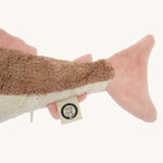 A closeup of the Senger organic cotton pink fish toy's tail and label