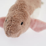 A head-on closeup of the Senger pink fish's cuddly toy face