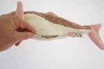 A hand unzipping the belly of the Senger organic cotton cuddly stuffed toy, to take out the heating bag from inside