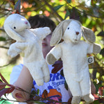 Senger dog and sheep puppet toys in use on a child's hands.