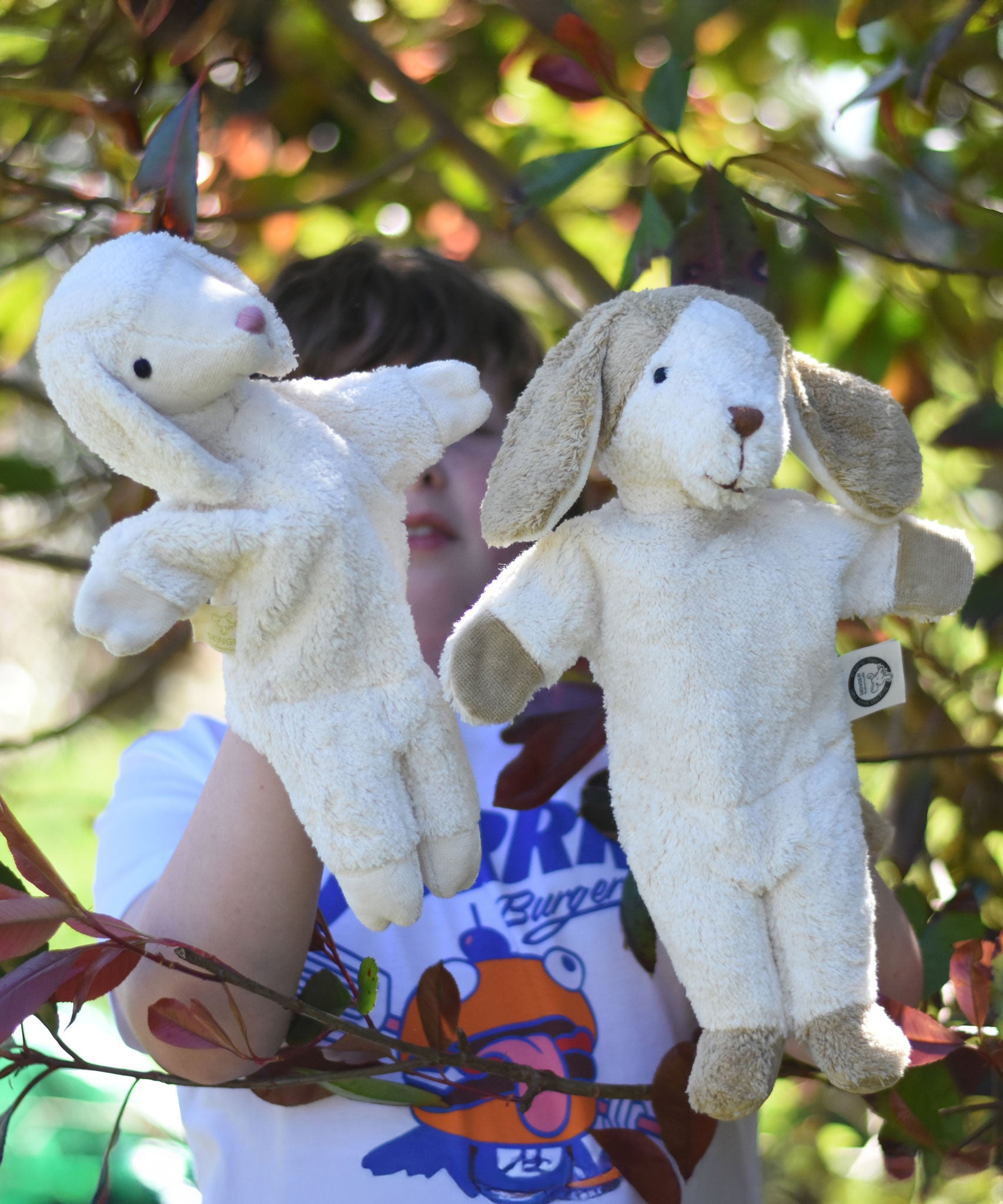 Senger dog and sheep puppet toys in use on a child's hands.