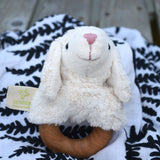 A Senger sheep baby grasping toy placed on a fern print Etta Loves sensory muslin cloth. 