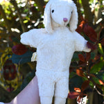 A Senger white sheep organic cotton puppet in use on a child's hand.