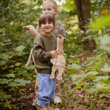 A child holding a Senger small Cuddly Goose organic soft toy in a creamy Linen colour. A child holding the large goose can be seen in the background. These soft toys are created from the highest quality, sustainable and traceable natural materials. Senger cuddly animal toys and soft dolls are handmade in Germany with love and attention to detail and we are proud Senger stockists here at Babipur. 