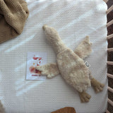 A Senger small Cuddly Goose organic soft toy in a creamy Linen colour placed in an empty crib. These soft toys are created from the highest quality, sustainable and traceable natural materials. Senger cuddly animal toys and soft dolls are handmade in Germany with love and attention to detail and we are proud Senger stockists here at Babipur. 