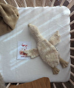 A Senger small Cuddly Goose organic soft toy in a creamy Linen colour placed in an empty crib. These soft toys are created from the highest quality, sustainable and traceable natural materials. Senger cuddly animal toys and soft dolls are handmade in Germany with love and attention to detail and we are proud Senger stockists here at Babipur. 