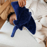 The Senger small cuddly manta Ray stuffed organic toy, being held by a toddler