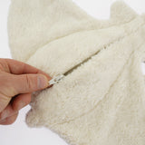 The under side of the Senger organic cotton small manta ray stuffed cuddly toy, with a hand opening the zip
