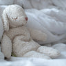 Senger GOTS organic cotton small cuddly white sheep toy sitting on against a blanket