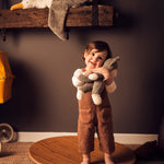 A child standing on a Wobbel 360 cuddling a Senger Small Floppy Cat.