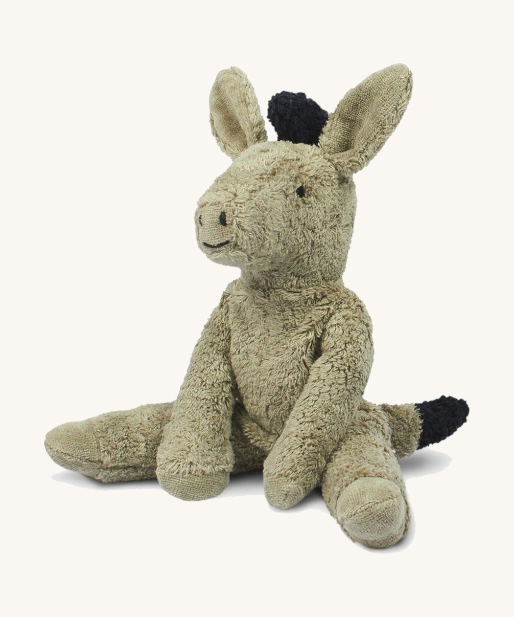 The Senger small floppy donkey - a cuddly, organic cotton stuffed animal with a natural wool filling. It has grey plush fur and is in a seated position. 
