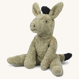 The Senger small floppy donkey - a cuddly, organic cotton stuffed animal with a natural wool filling. It has grey plush fur and is in a seated position. 