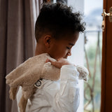 Child with a Senger GOTS organic cotton small cream cuddly goose soft toy over their shoulder 