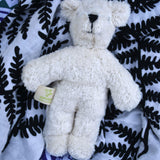  Senger white baby bear placed on an Etta Loves fern print sensory muslin cloth.