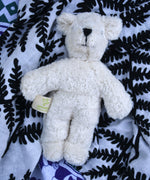  Senger white baby bear placed on an Etta Loves fern print sensory muslin cloth.