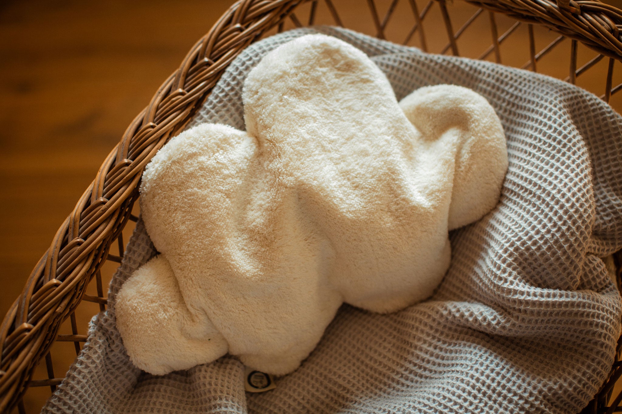 A white cloud shaped Senger warming cushion. 