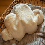 A white cloud shaped Senger warming cushion. 