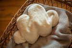 A white cloud shaped Senger warming cushion. 