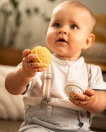  looking down and engaging with the Sophie The Giraffe - Once Upon A Time 5 Senses Musical Balls set