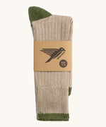The Silverstick Caburn Organic Cotton Socks in the Greto colour way shown folded in half and placed in a cardboard packaging sleeve. 