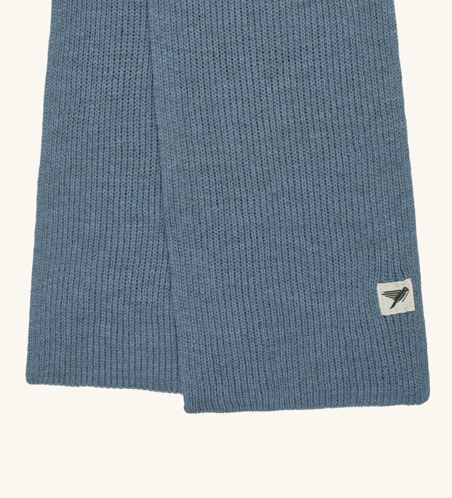 A close up of the logo label on the Silverstick Cirrus Merino Wool Scarf in a Celeste blue colour. Silverstick are proudly made in the UK and stocked here at Babipur. 
