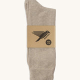 A pair of cream GOTS-Certified organic cotton everyday socks by Silverstick in recyclable paper packaging, made in Britain.