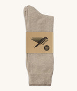 A pair of cream GOTS-Certified organic cotton everyday socks by Silverstick in recyclable paper packaging, made in Britain.