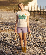 A woman wearing the Silverstick Habitats Organic T-Shirt in the Angora colourway.