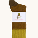 Silverstick Matt Sewell Cirl Bunting Merino Socks shown folded over and placed into their paper packaging sleeve.