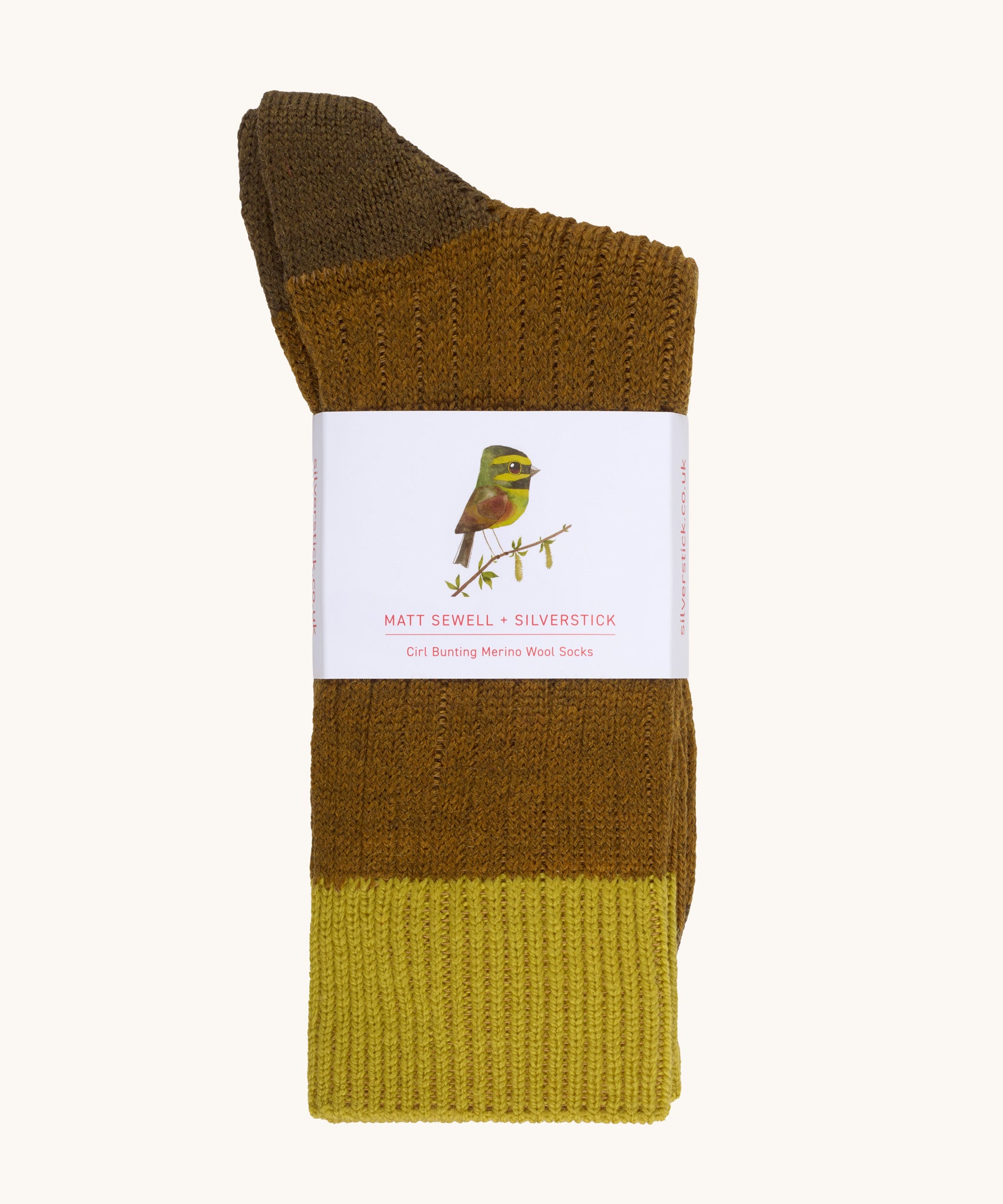 Silverstick Matt Sewell Cirl Bunting Merino Socks shown folded over and placed into their paper packaging sleeve.