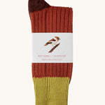 Silverstick Matt Sewell Hawfinch Merino Socks shown folded over and placed into their paper packaging sleeve. 