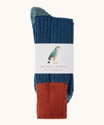 Silverstick Matt Sewell Merlin Merino Socks shown folded over and placed in their paper packaging sleeve. 