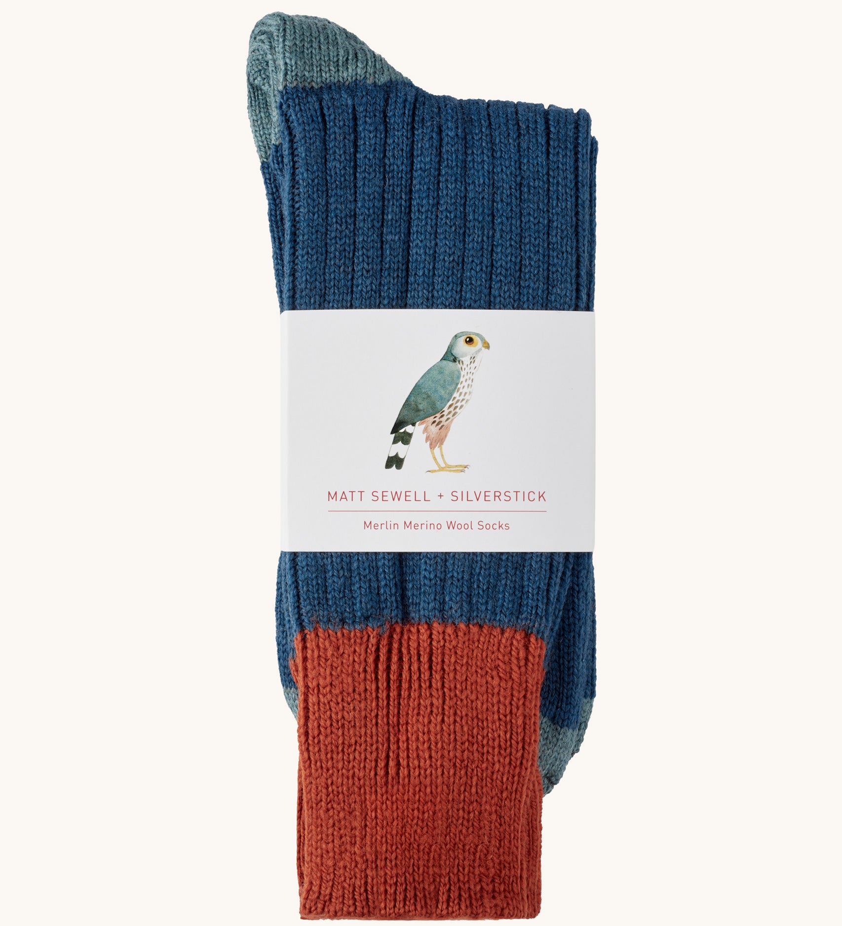 Silverstick Matt Sewell Merlin Merino Socks shown folded over and placed in their paper packaging sleeve. 
