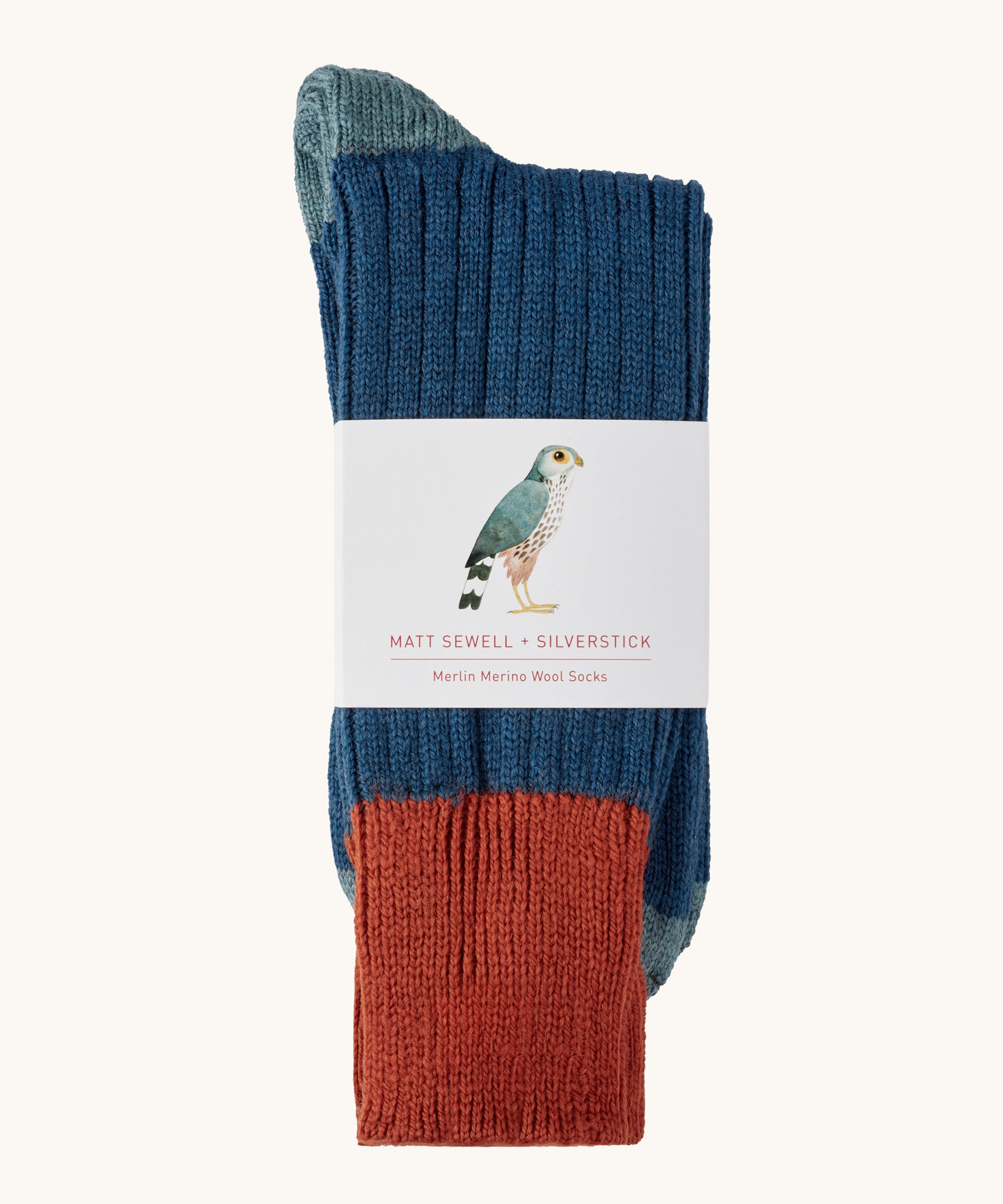 Silverstick Matt Sewell Merlin Merino Socks shown folded over and placed in their paper packaging sleeve. 